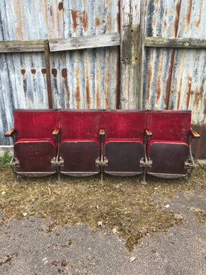 A row of red velvet flip cinema or theatre seats