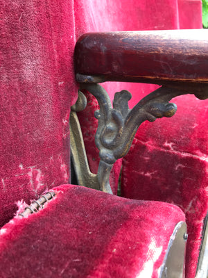 A row of red velvet flip cinema or theatre seats