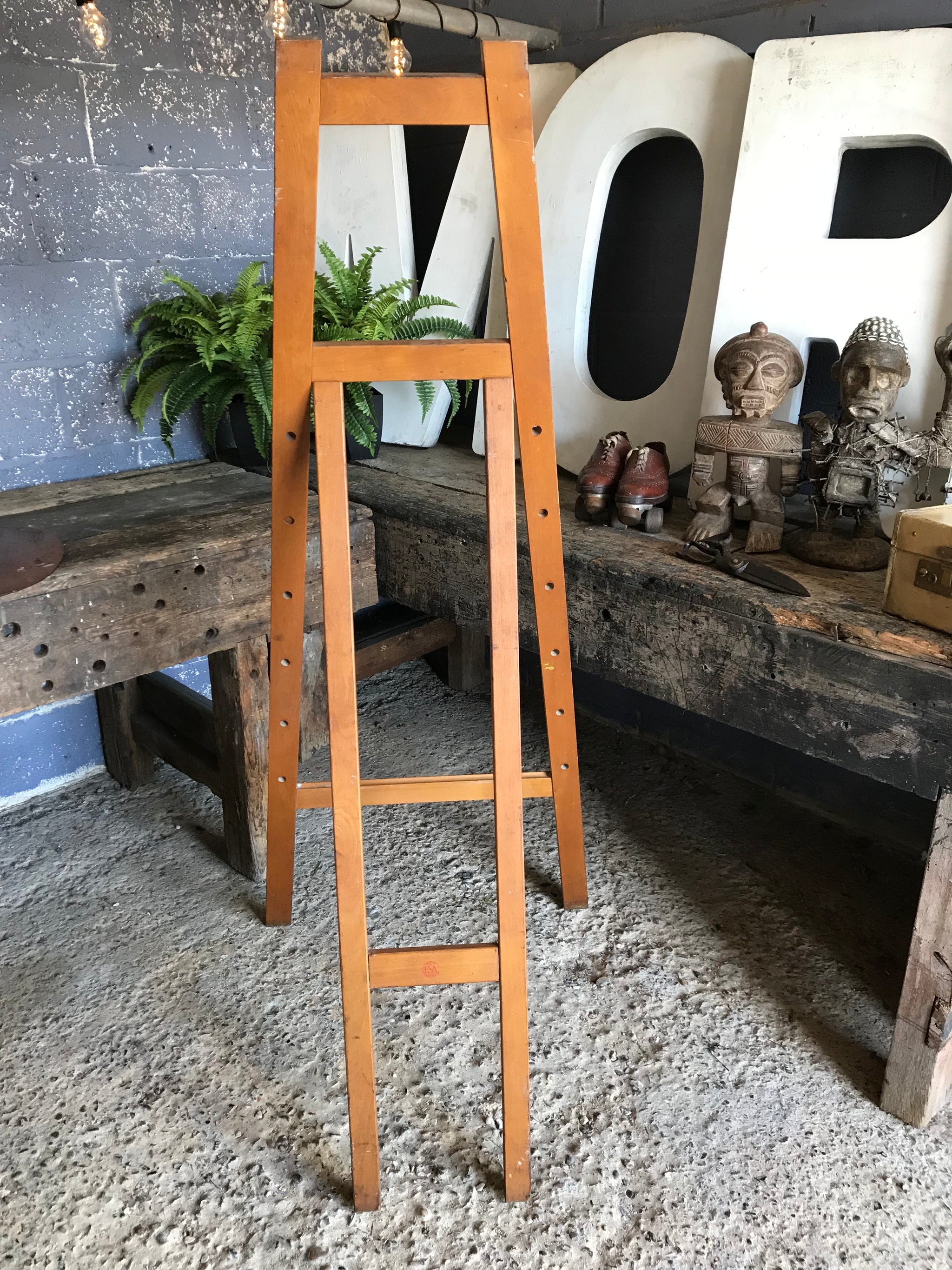 A flat full size floor standing studio peg easel