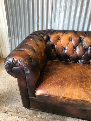 A brown leather three seater button back Chesterfield sofa