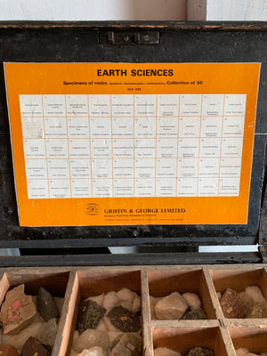 A large geological rock specimen collection in a wooden box