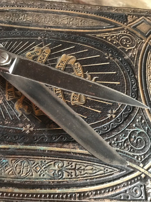 A pair of large metal tailor's scissors shears