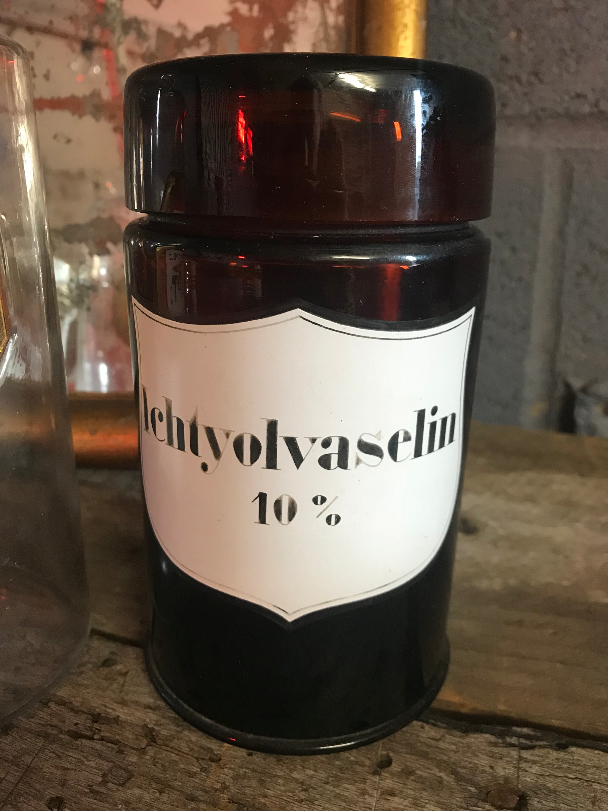 A large amber glass apothecary jar with lid