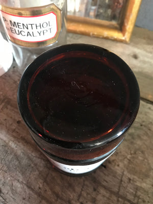 A large amber glass apothecary jar with lid