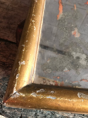 A heavily distressed gilt mercury wall mirror