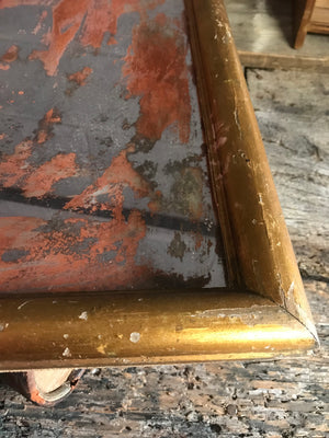 A heavily distressed gilt mercury wall mirror