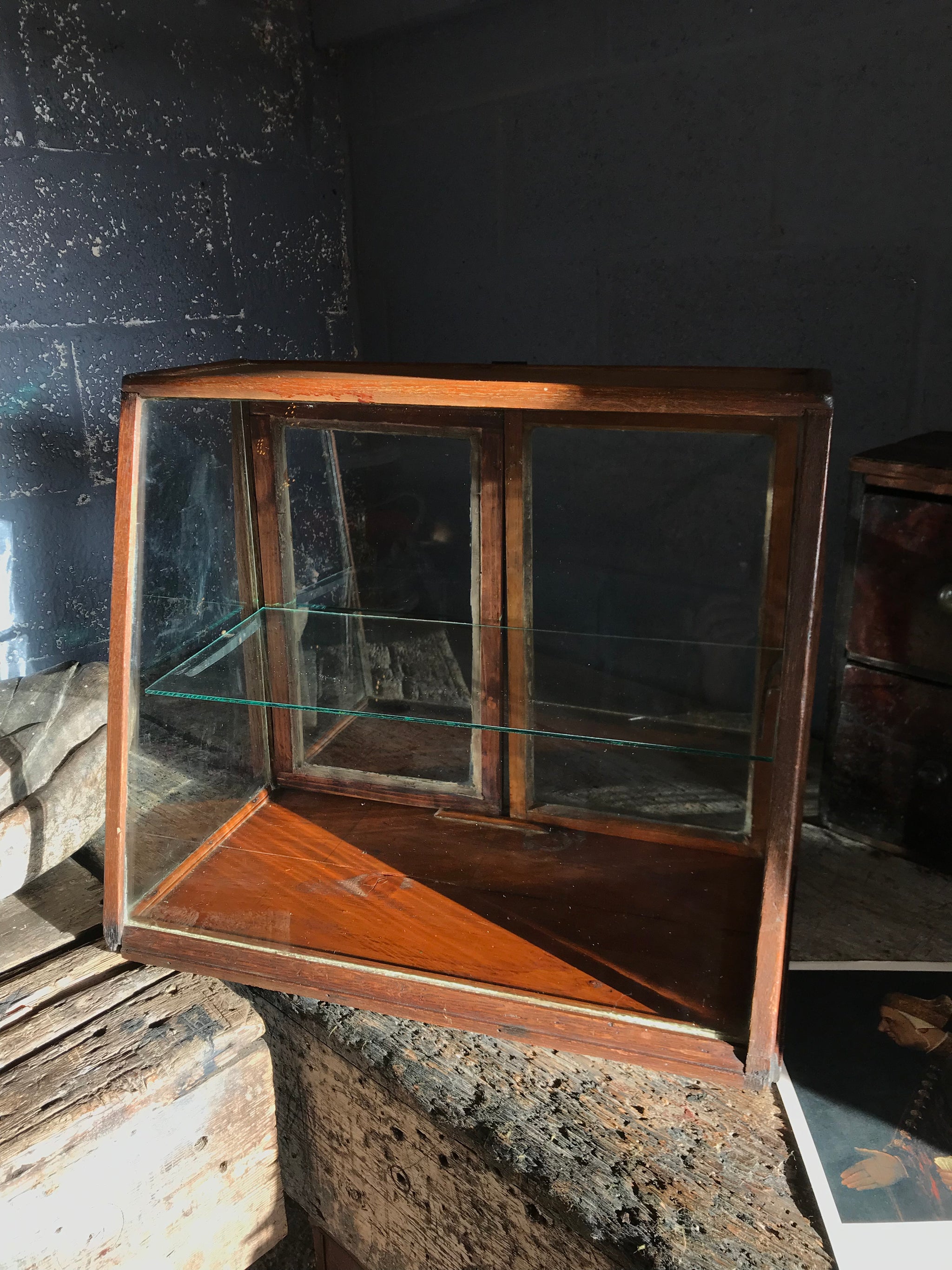 A sloping counter top glass shop display cabinet
