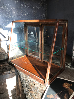 A sloping counter top glass shop display cabinet