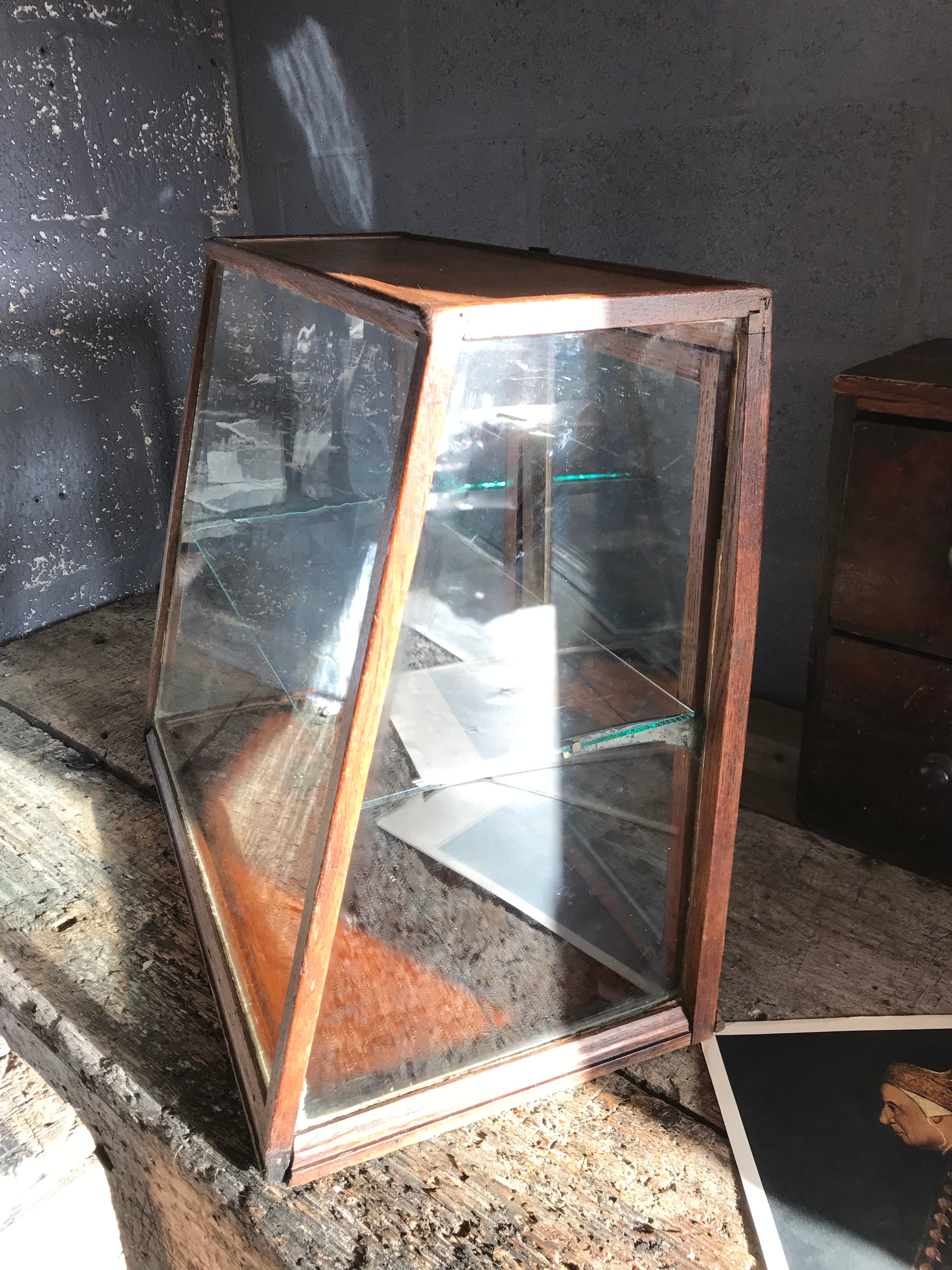 A sloping counter top glass shop display cabinet