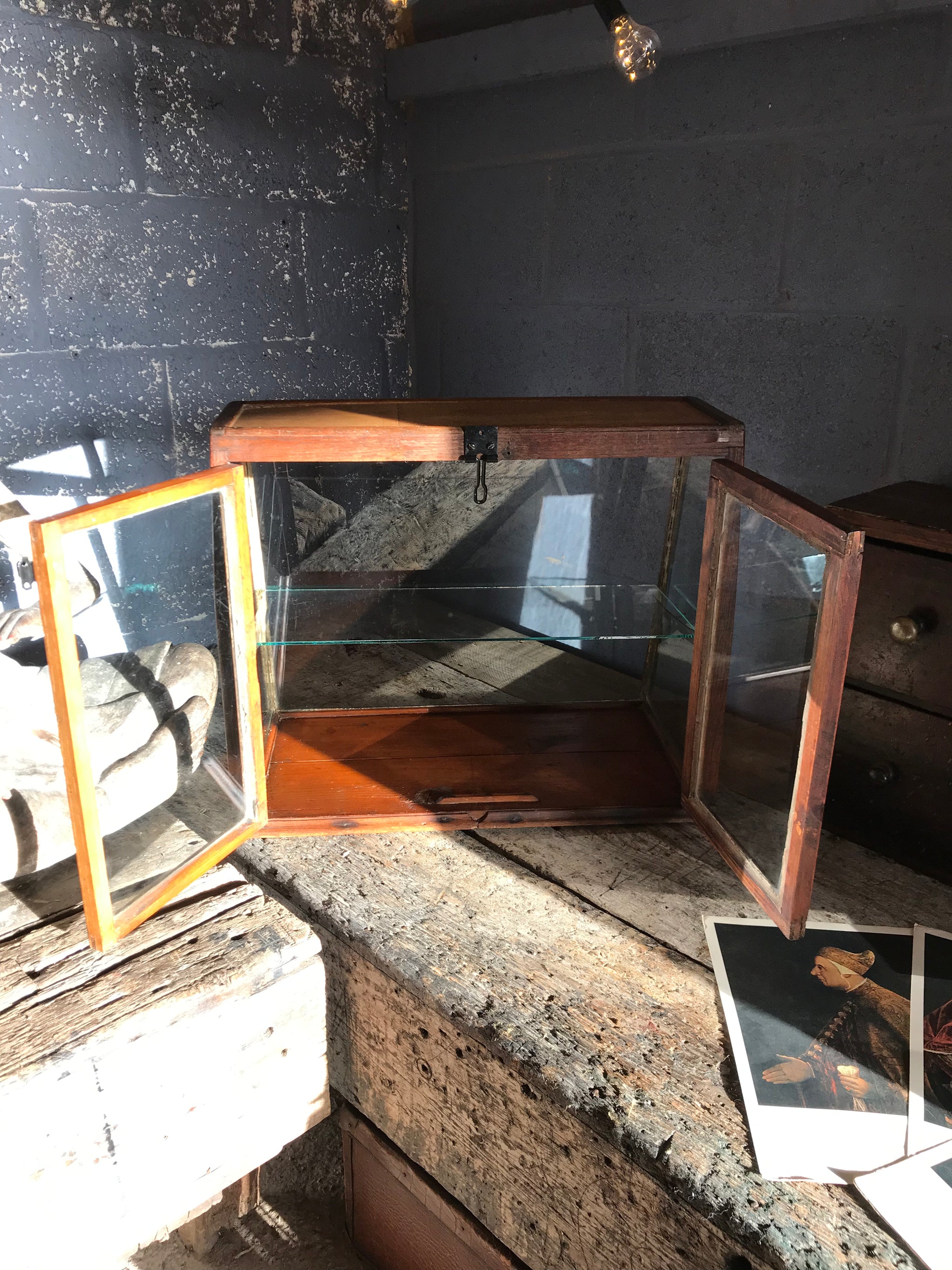 A sloping counter top glass shop display cabinet
