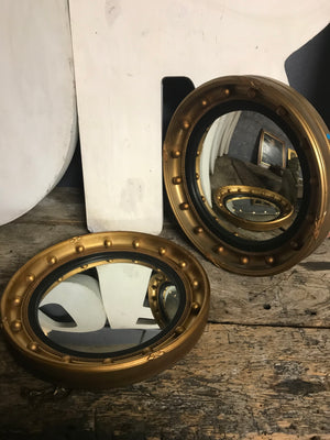 A rare pair of gilt convex Regency ball mirrors