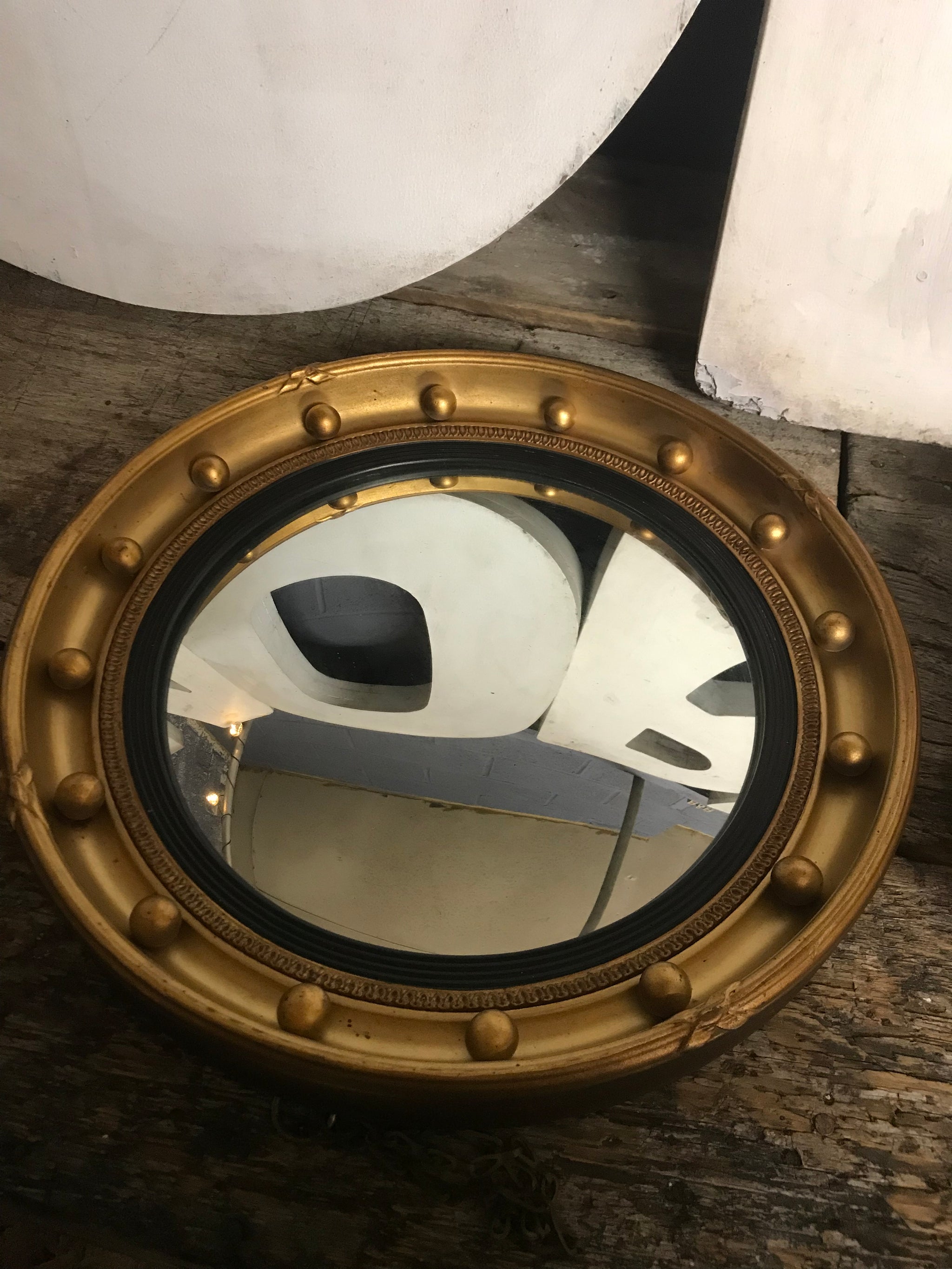 A rare pair of gilt convex Regency ball mirrors