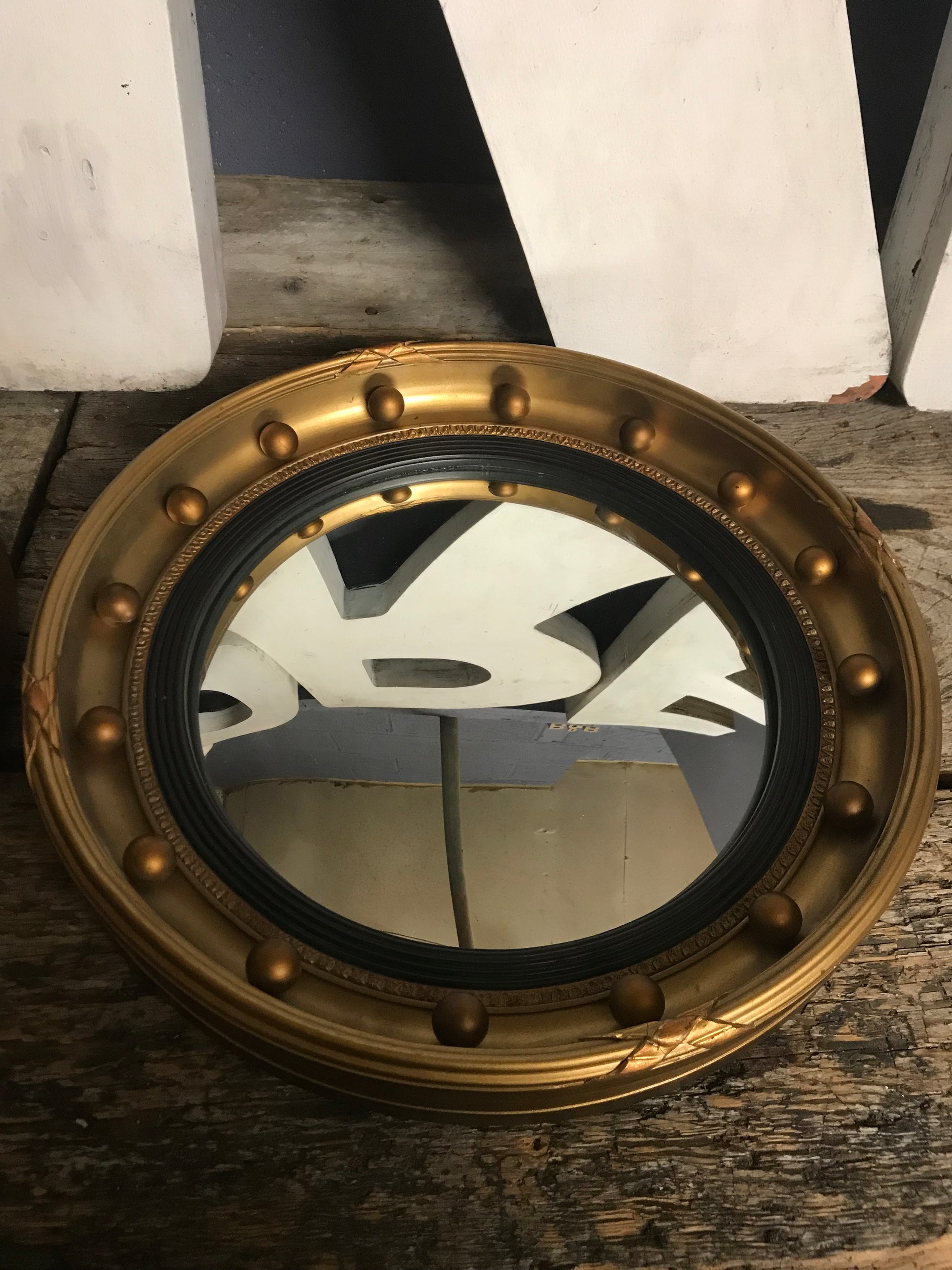 A rare pair of gilt convex Regency ball mirrors