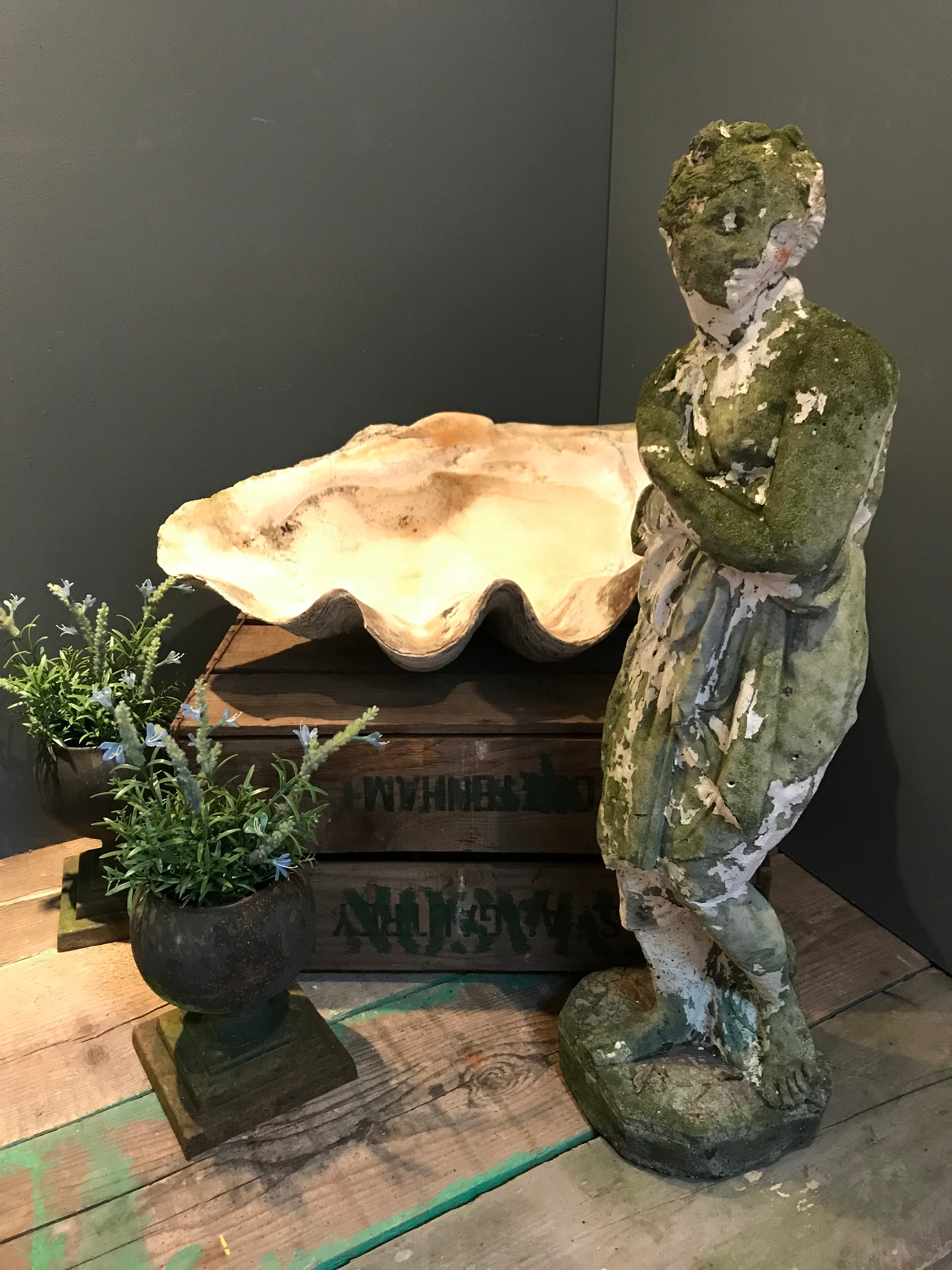 A large neoclassical stone statue of Pandora