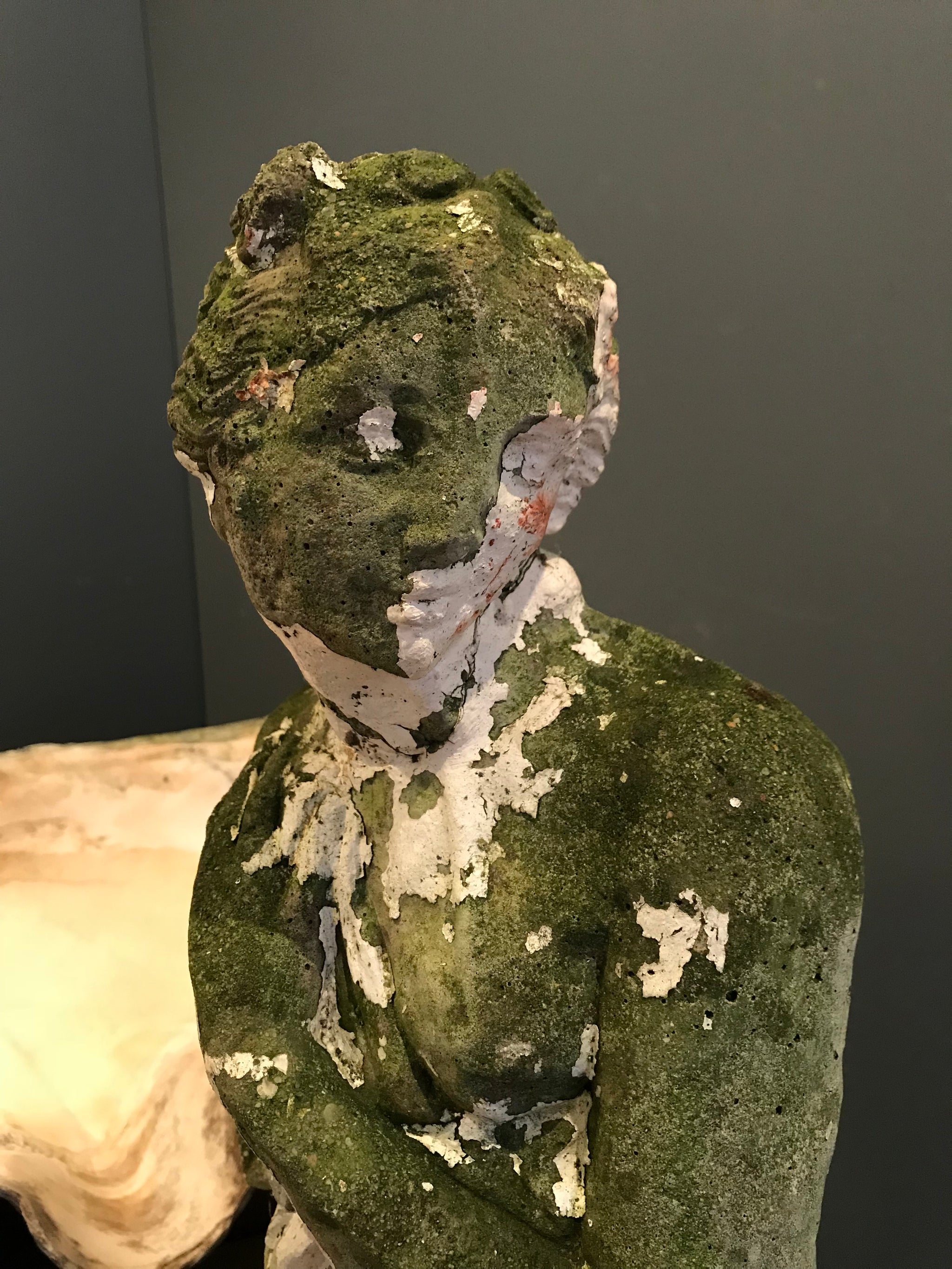 A large neoclassical stone statue of Pandora