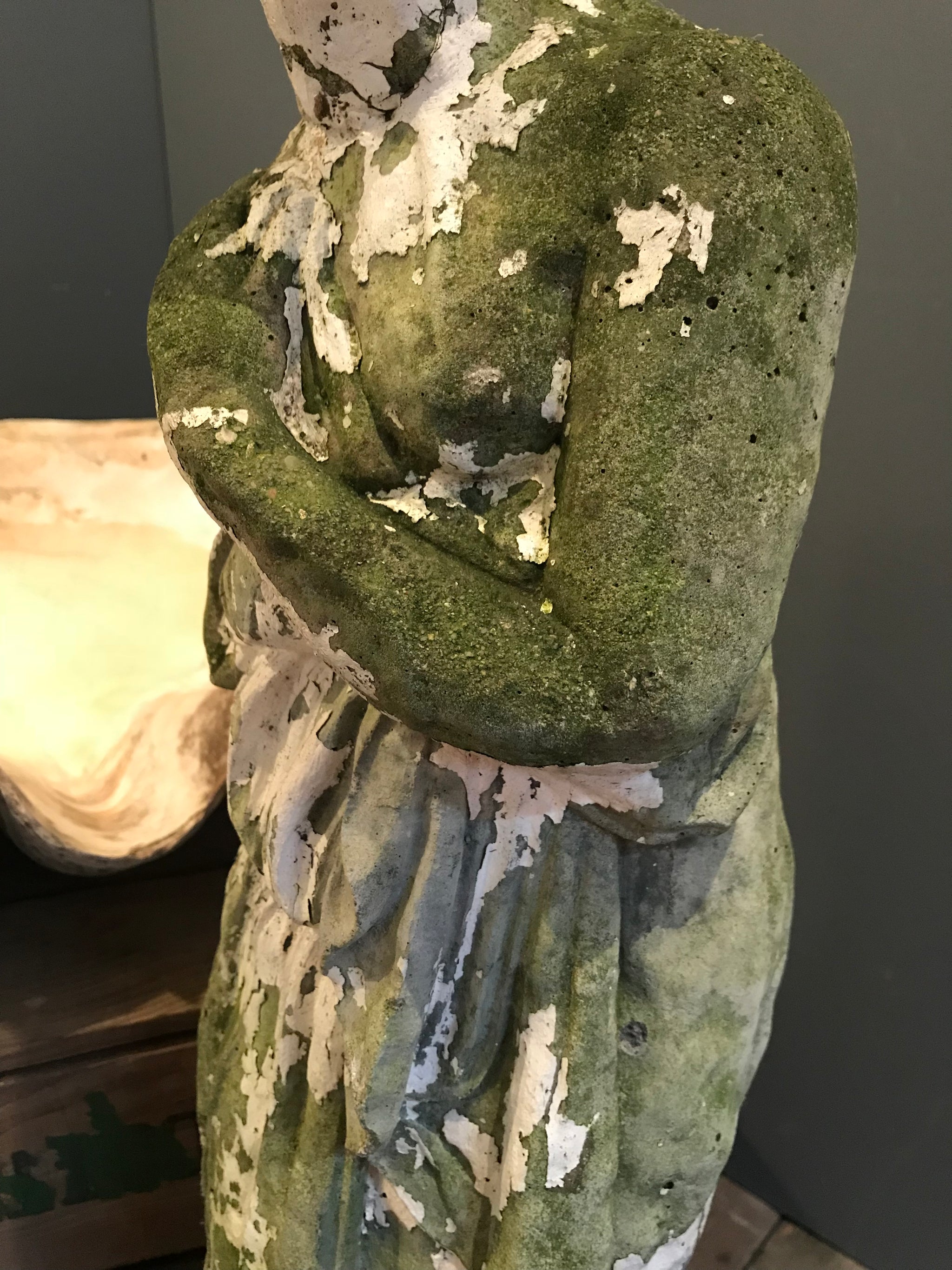 A large neoclassical stone statue of Pandora