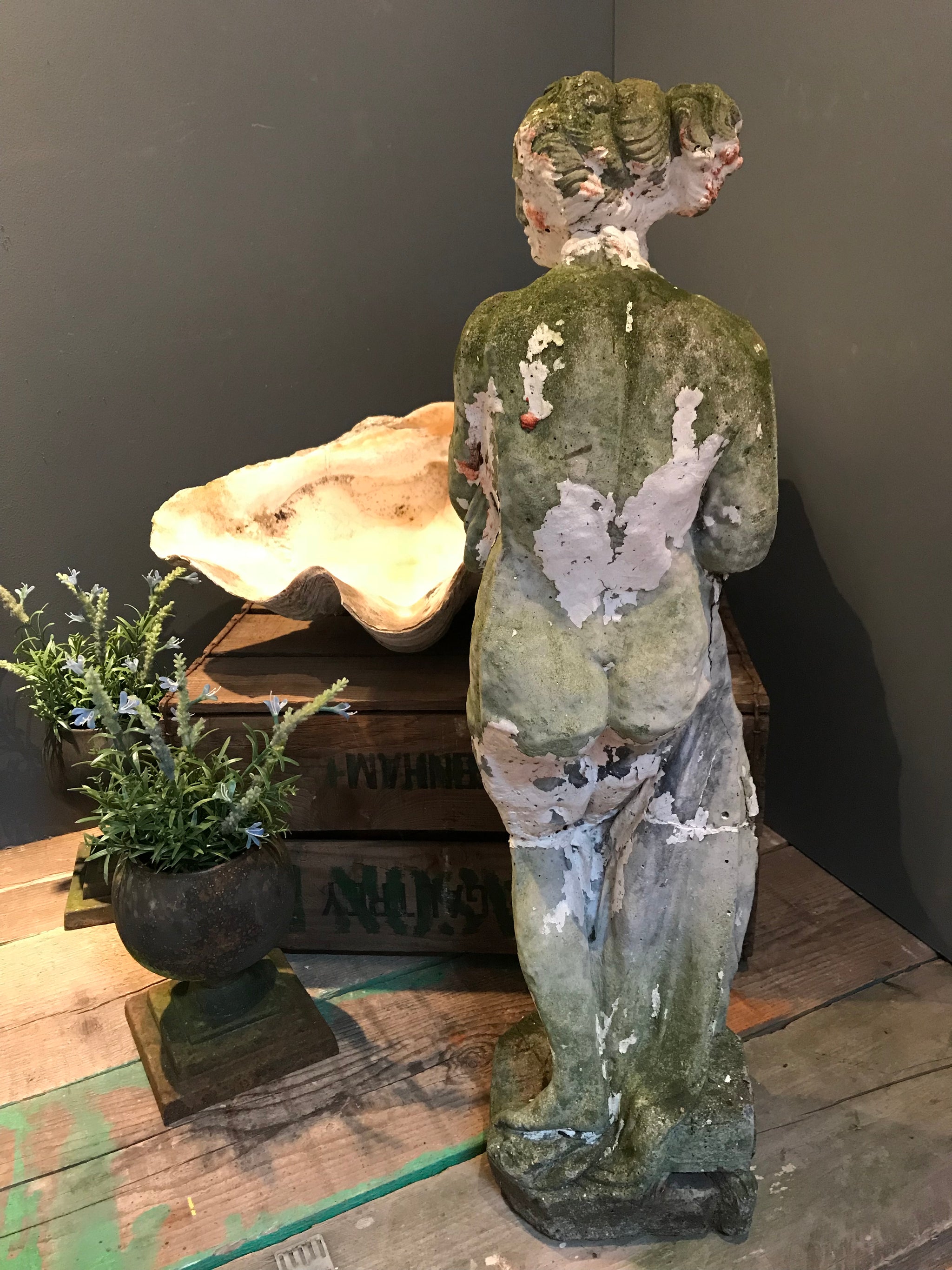 A large neoclassical stone statue of Pandora