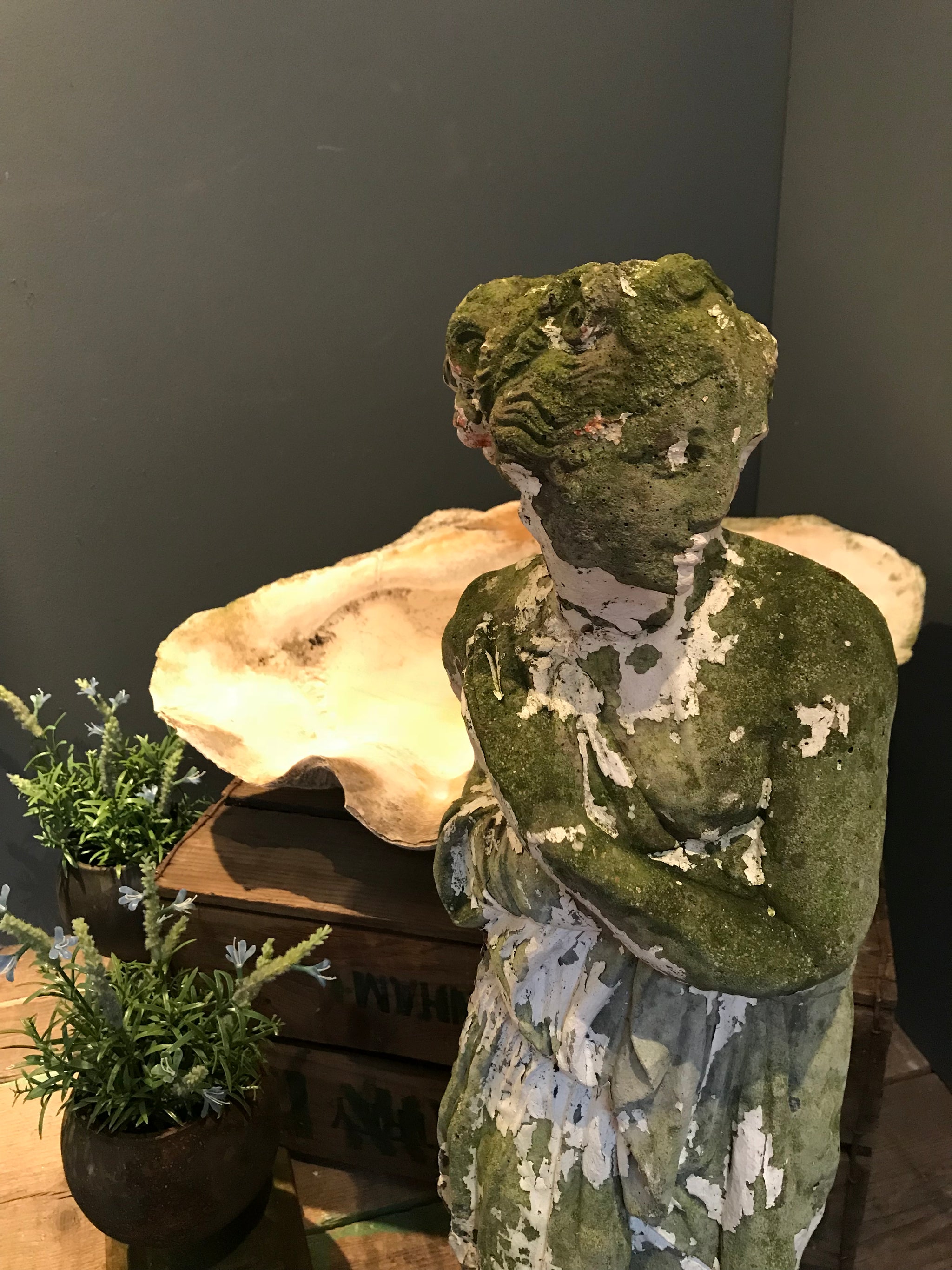 A large neoclassical stone statue of Pandora