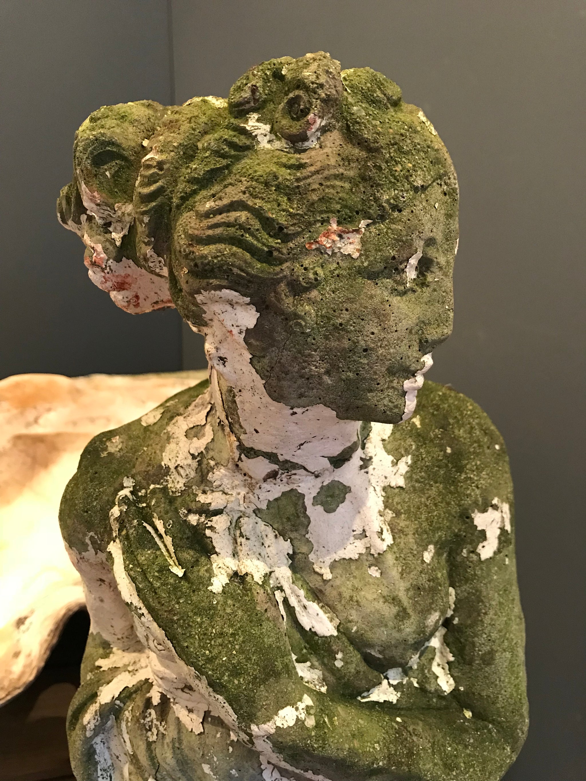 A large neoclassical stone statue of Pandora