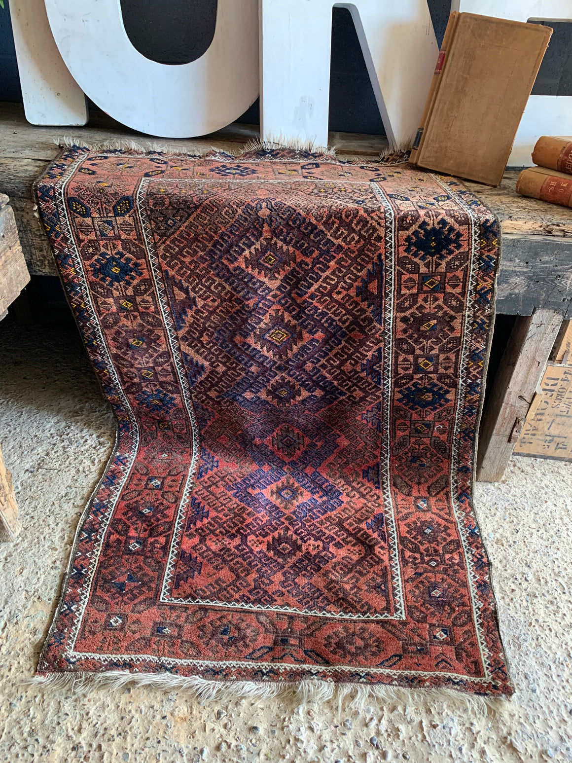 A large rectangular red brown ground Persian rug