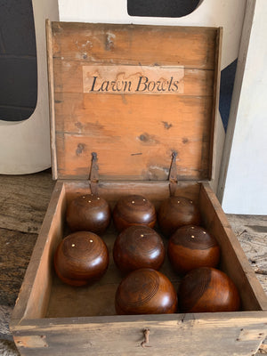 A set of eight wooden lignum vitae lawn bowls in a wooden box