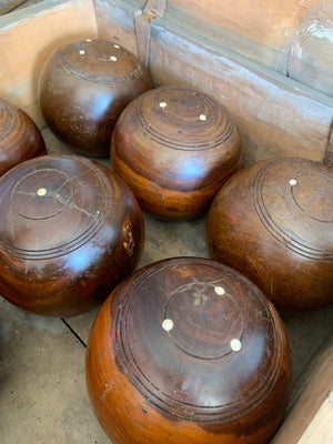 A set of eight wooden lignum vitae lawn bowls in a wooden box