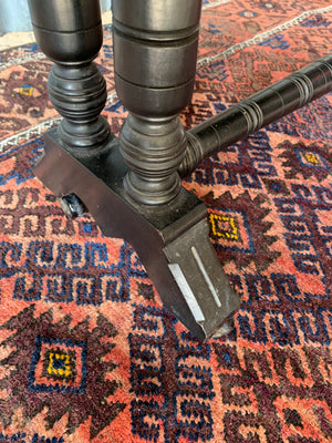 An ebonised drop leaf octagonal Sutherland table