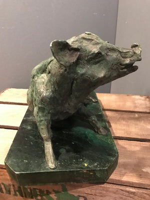 A verdigris bronze cire perdue pig sculpture on a green marble base
