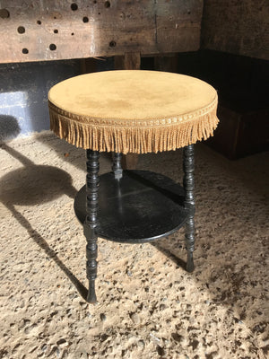 An early ebonised gypsy table with mustard velvet top