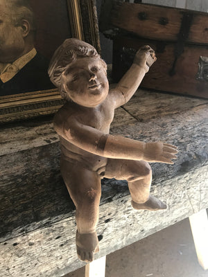 A large 19th Century carved wooden cherub putto figure