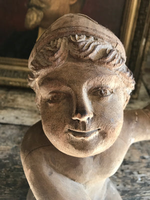 A large 19th Century carved wooden cherub putto figure