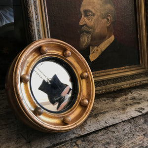 A gilt 19th century miniature porthole mirror