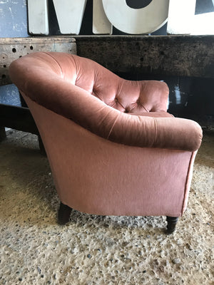 A pink velvet Hollywood Regency/Art Deco button back chair with brass castors