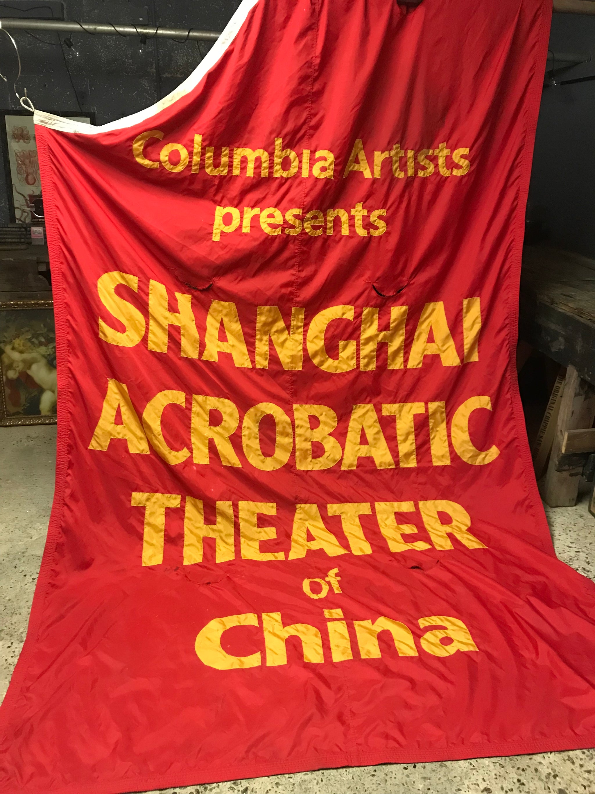 A large fairground or circus style Shanghai Acrobatic Theater of China banner