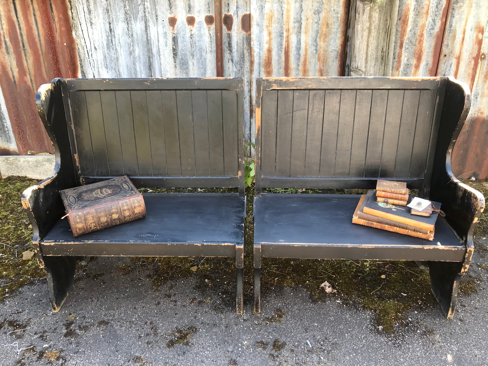 A pair of 19th Century black painted pews