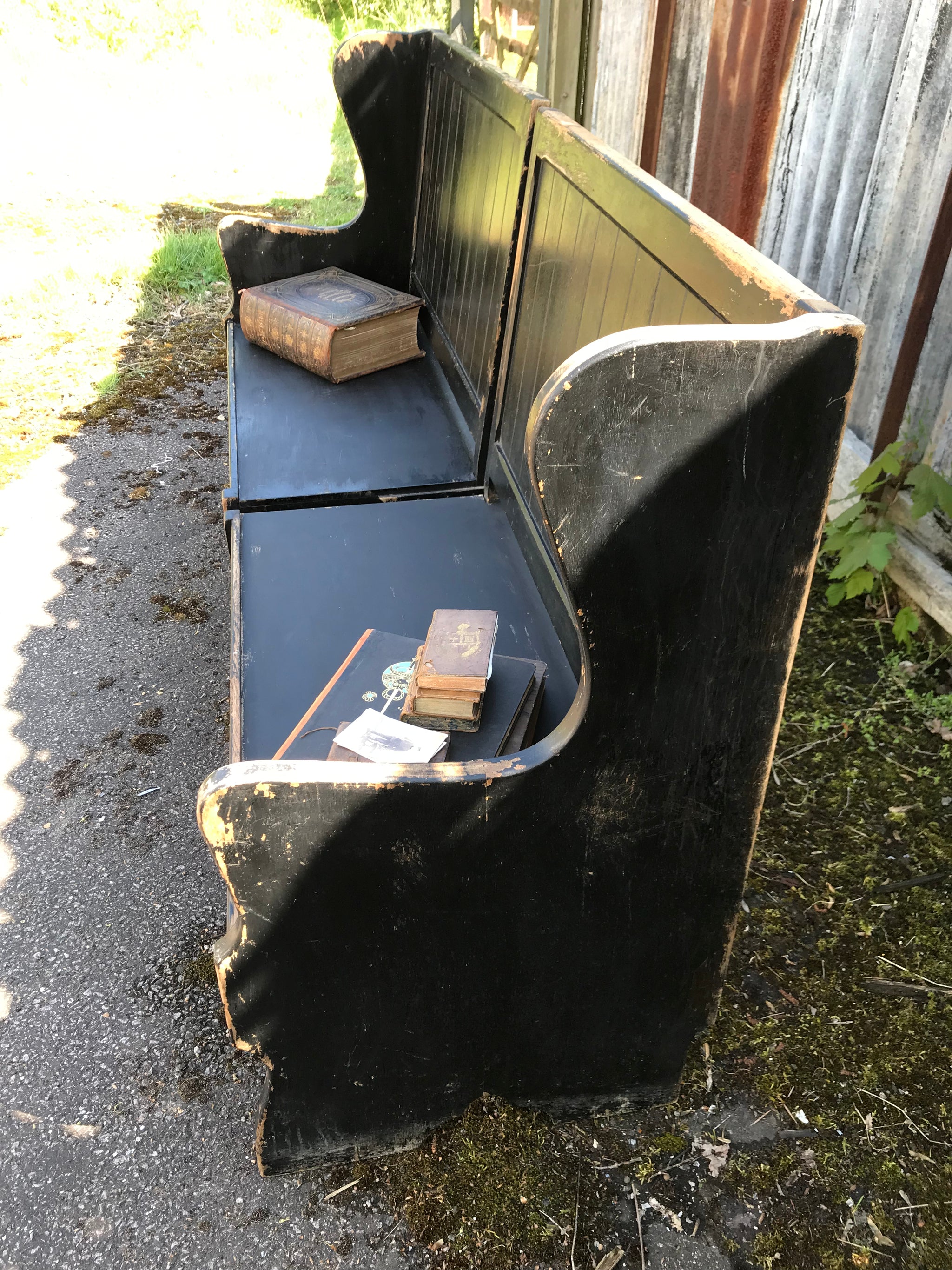 A pair of 19th Century black painted pews