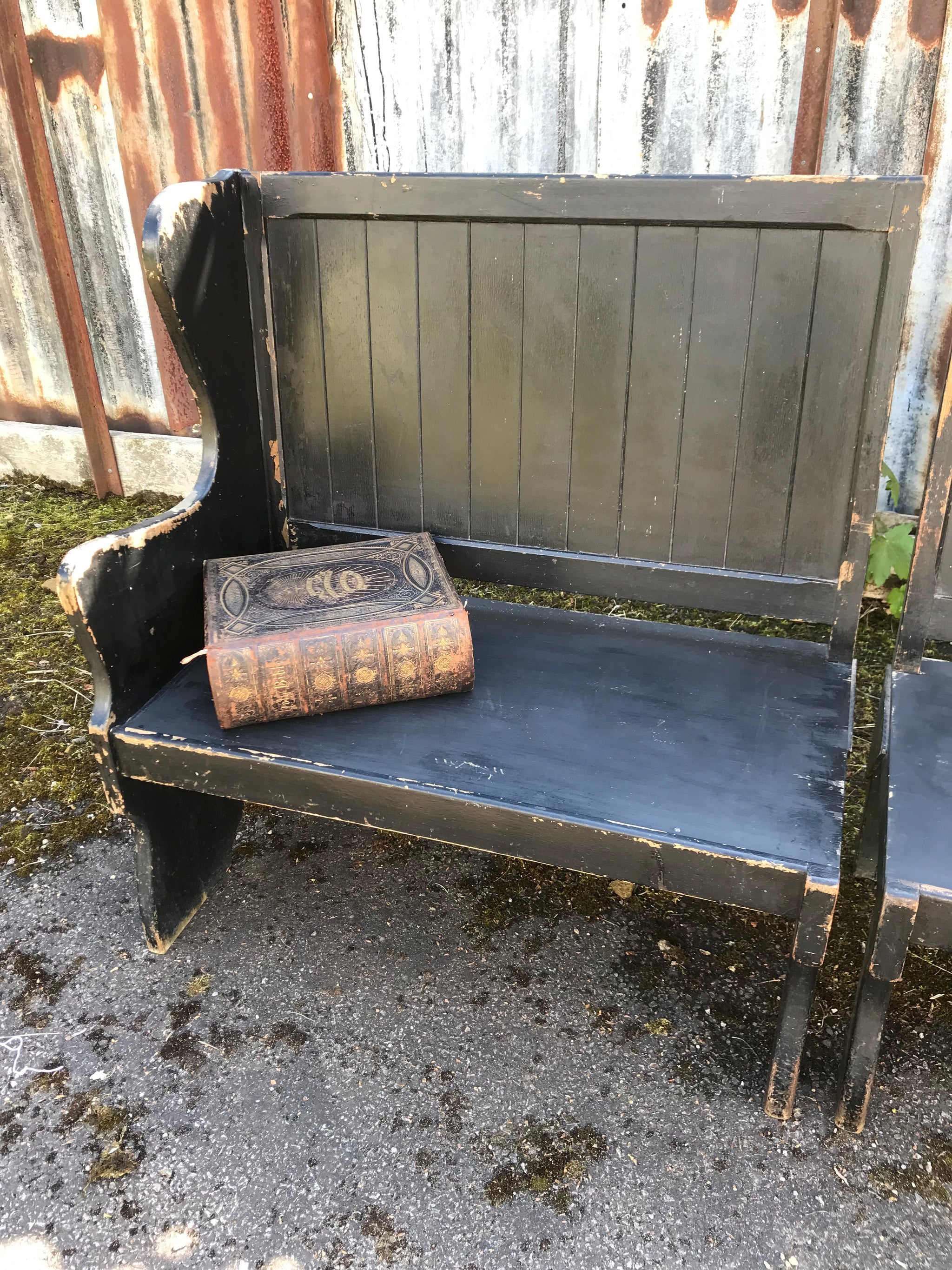 A pair of 19th Century black painted pews