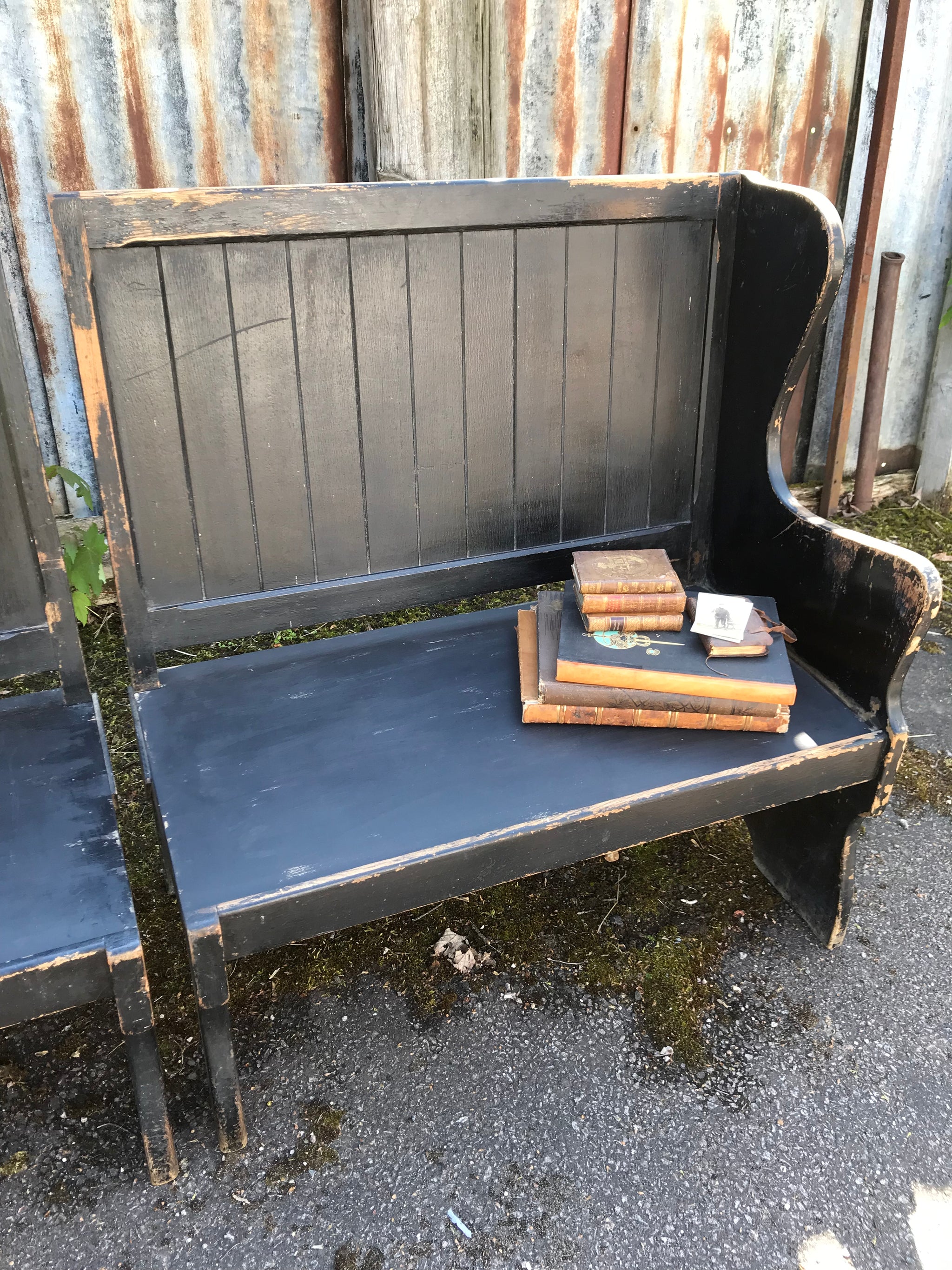 A pair of 19th Century black painted pews