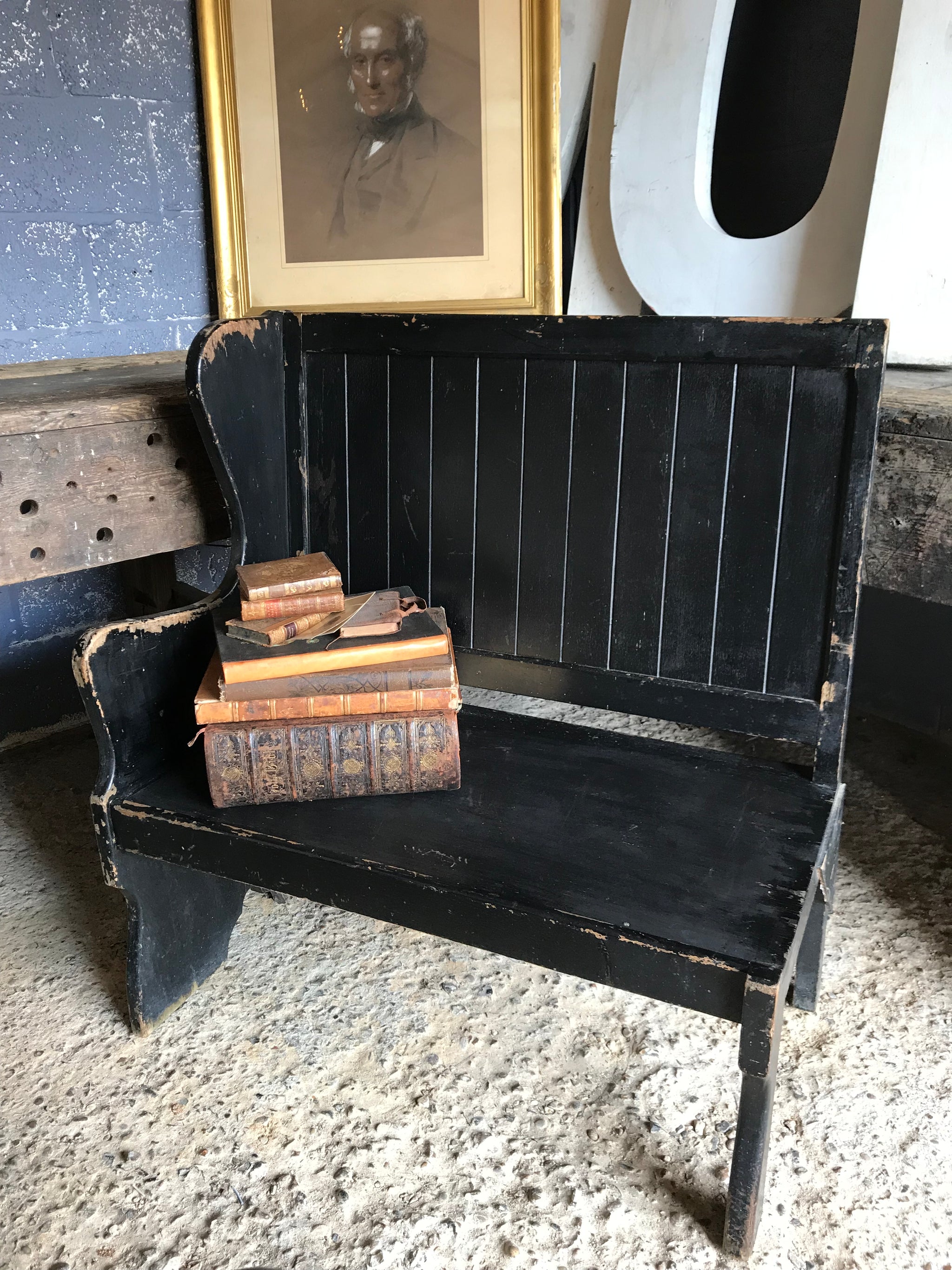A pair of 19th Century black painted pews