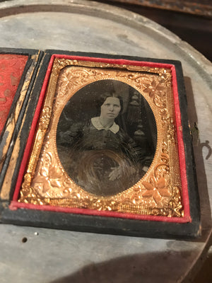 A 19th Century daguerreotype cased photograph of a lady with a lock of hair