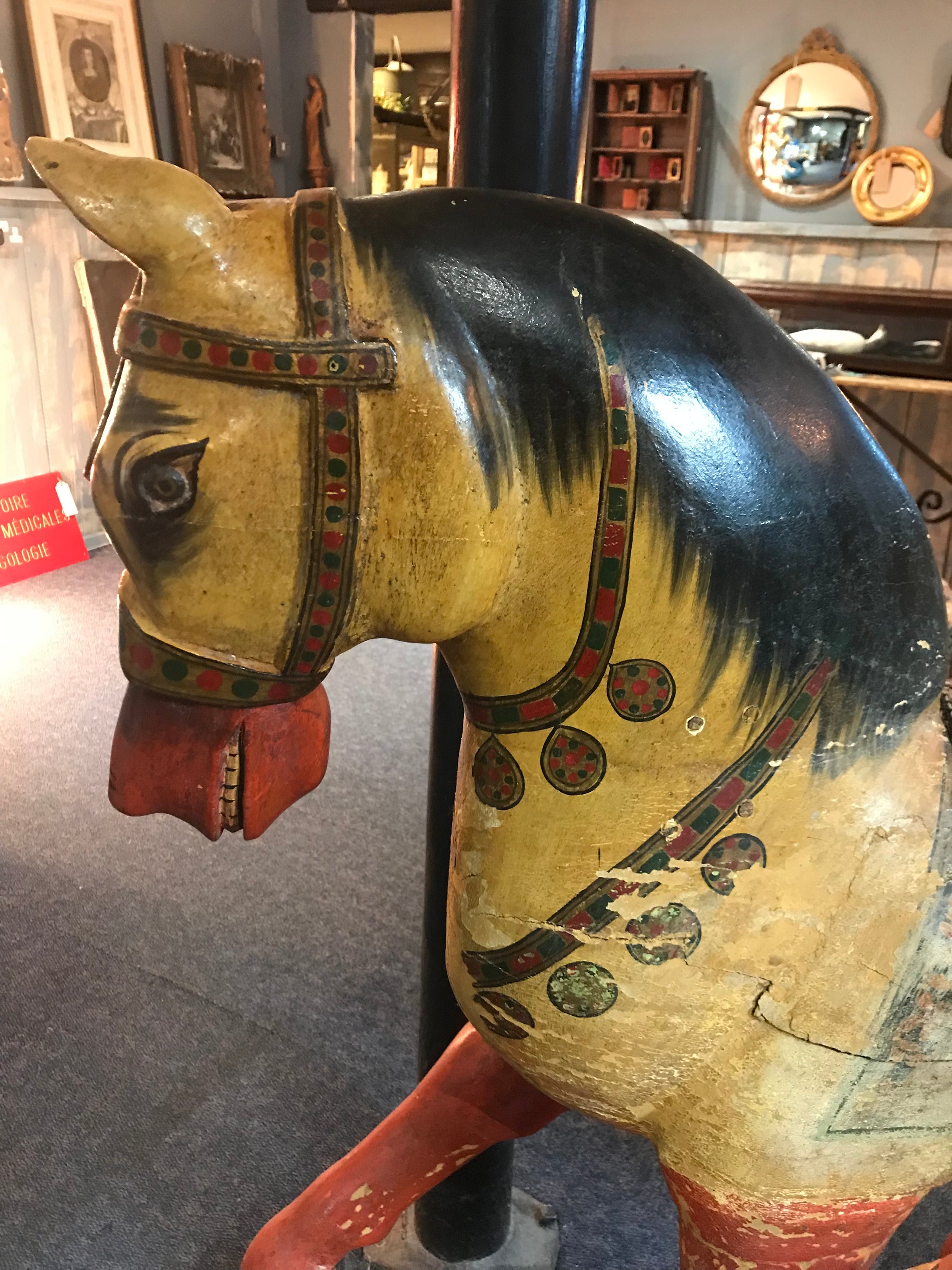 A large 19th Century Persian polychrome painted rocking horse on wheels