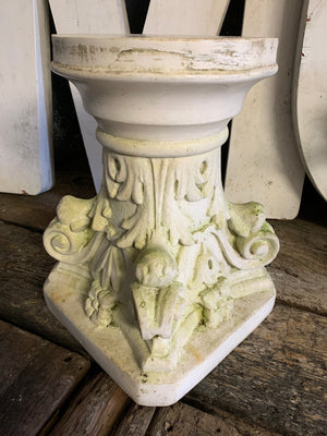 A white Corinthian column display stand