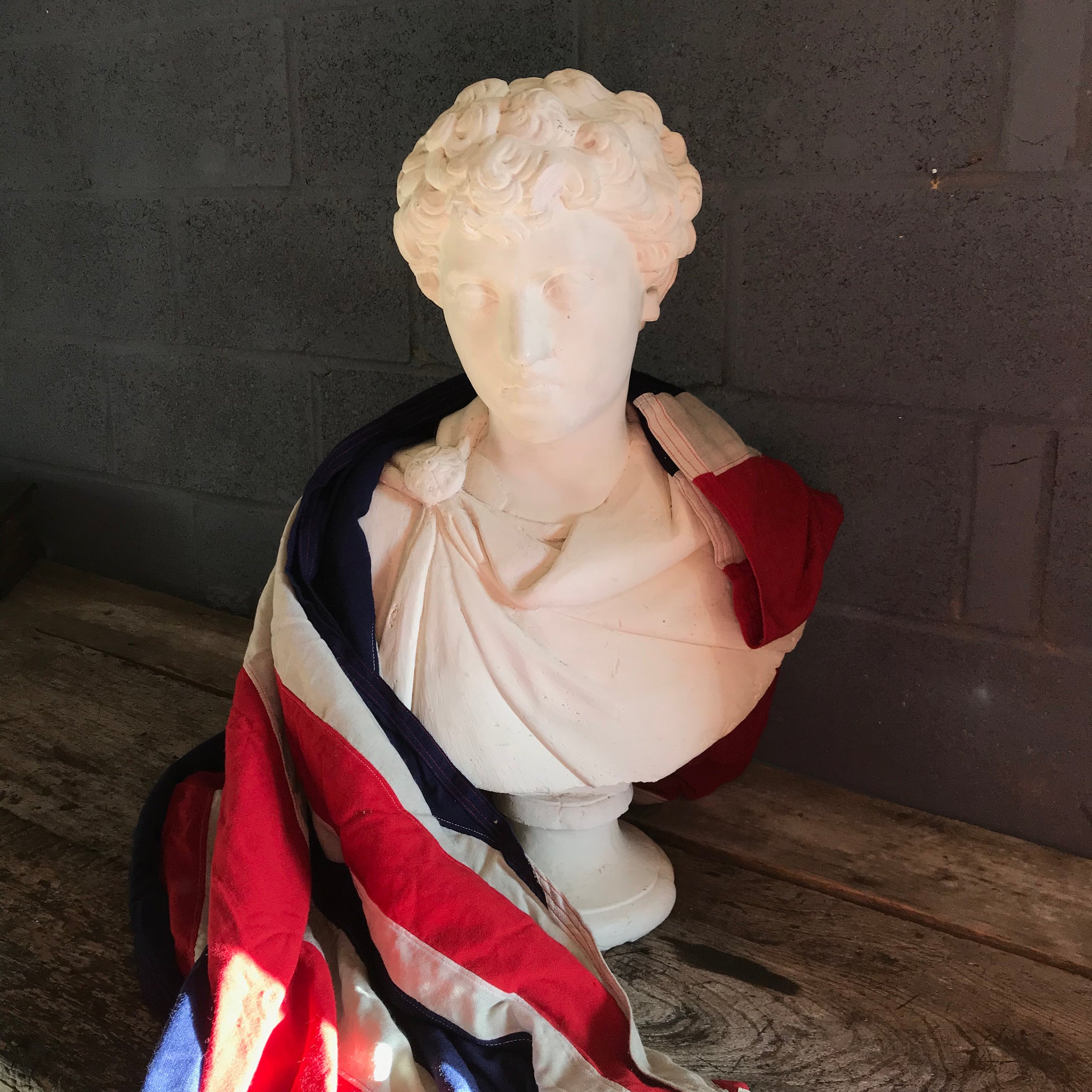 A large Neoclassical Roman bust in white plaster