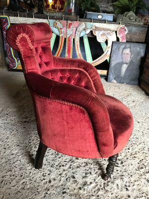 A 19th century red velvet button back chair