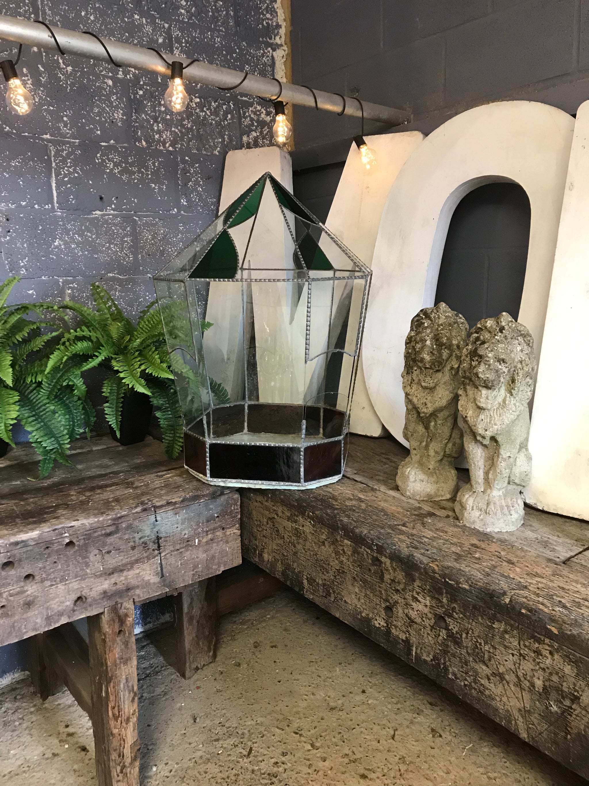 A pair of weathered cast stone lion statues