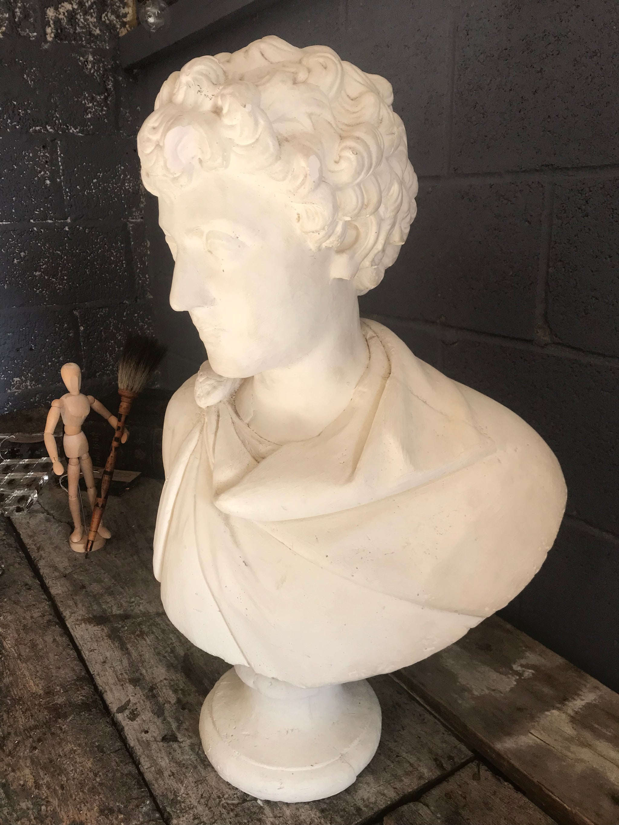 A large Neoclassical Roman bust in white plaster