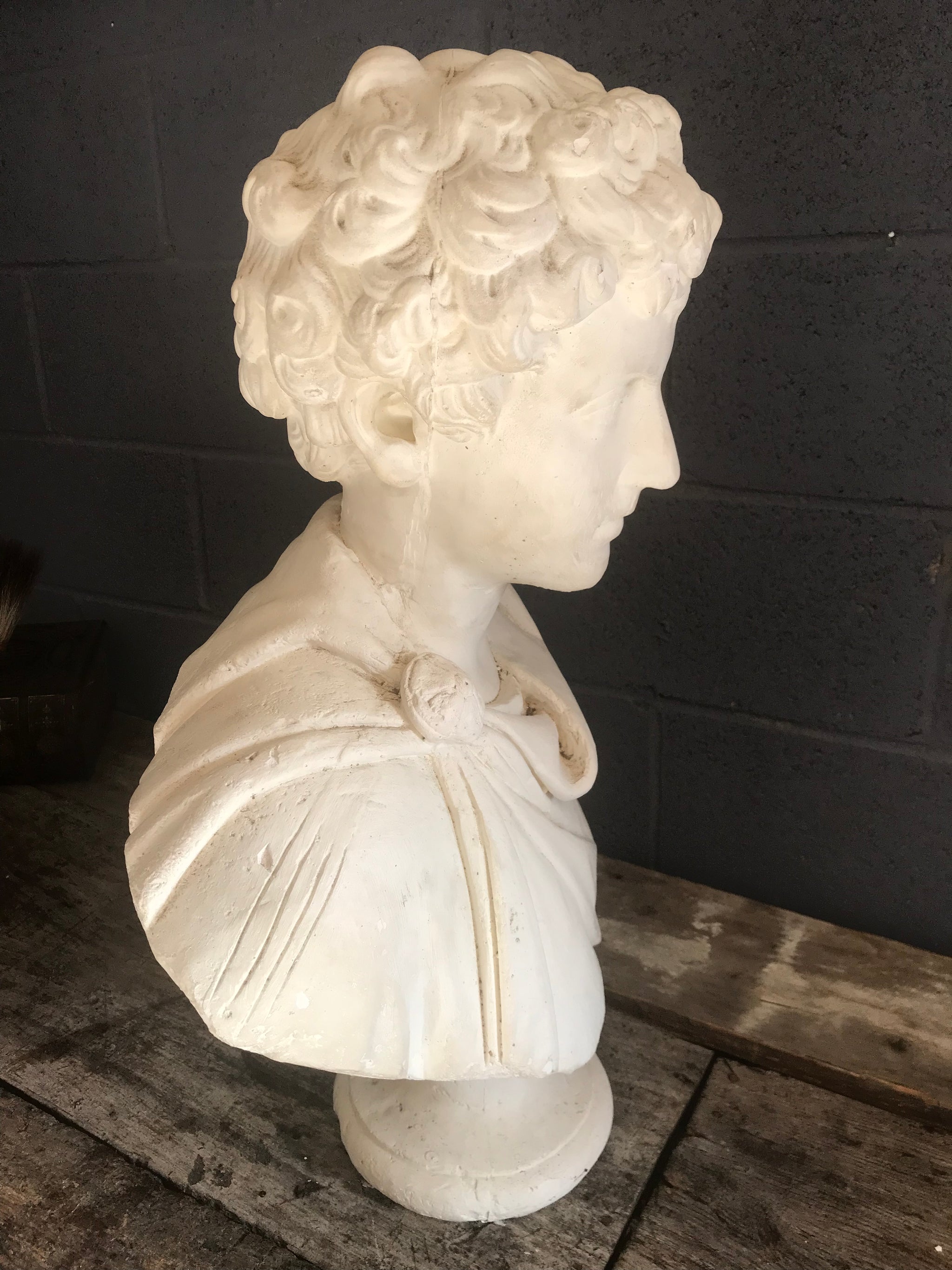 A large Neoclassical Roman bust in white plaster