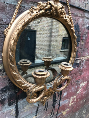 A round Rococo girandole mercury mirror