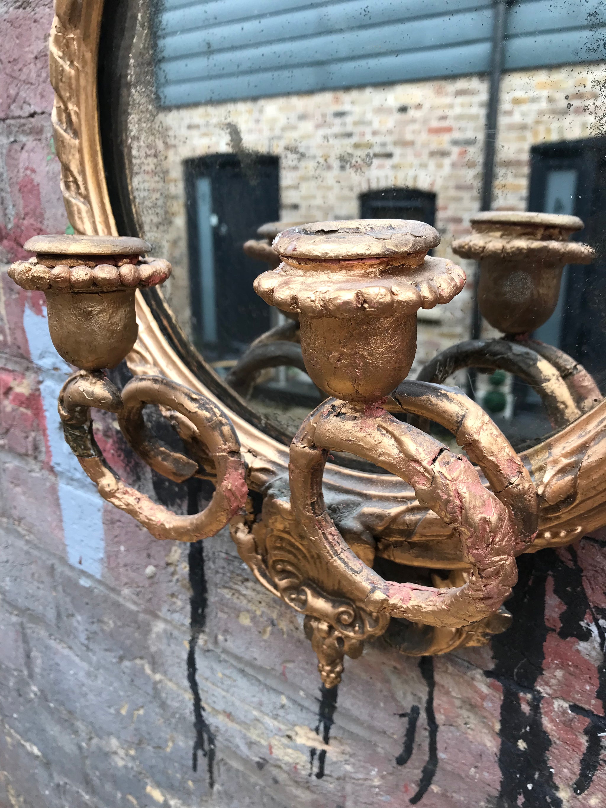 A round Rococo girandole mercury mirror