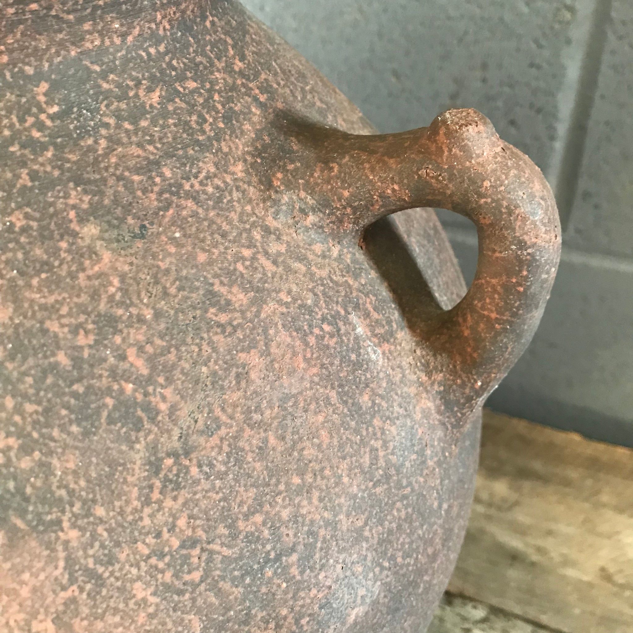 A pair of large terracotta urns with double lug handles